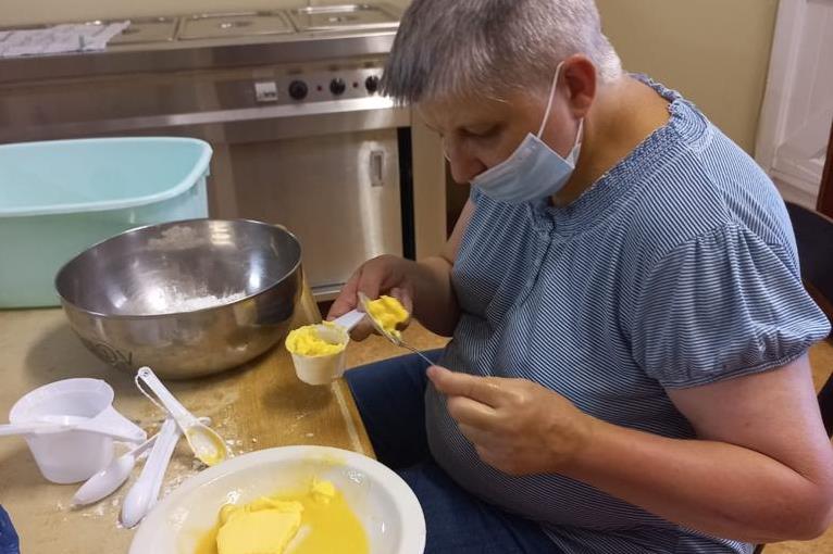 Visually impaired resident baking cupcakes